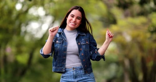 Happy Woman Dancing and Celebrating in Outdoor Setting