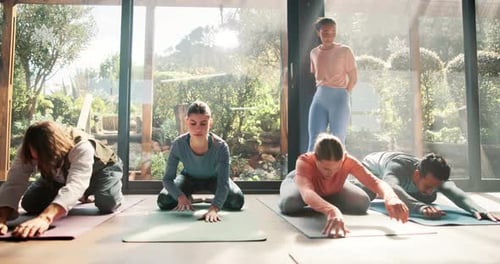 Young Adults Practicing Yoga Poses in Class
