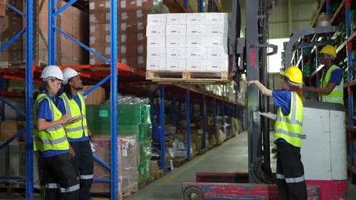 Warehouse worker controlling boxes in warehouse