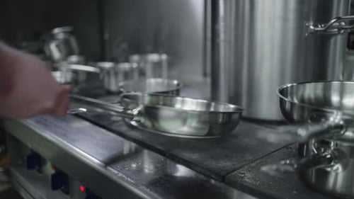 Cooking On Kitchen In Restaurant Closeup View Of Stove With Frying Pan Cook Mixing Vegetables