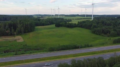 Highway road and wind turbine farm, aerial drone view