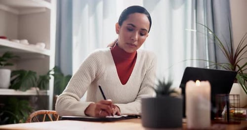 Business woman, writing and laptop with notebook for schedule, planning or tasks at home office