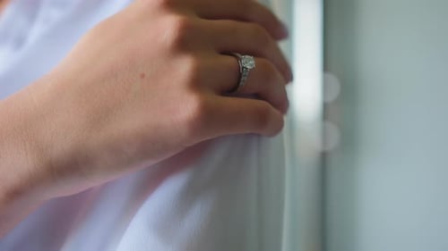 Bride's Hand with Wedding Ring Close Up White Dress Preparation of the Bride Morning of the Bride
