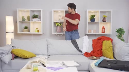 The lazy man is looking for documents in the mess and is happy to find it.
