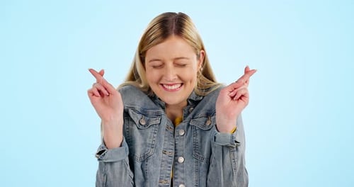 Woman Crossing Fingers and Smiling