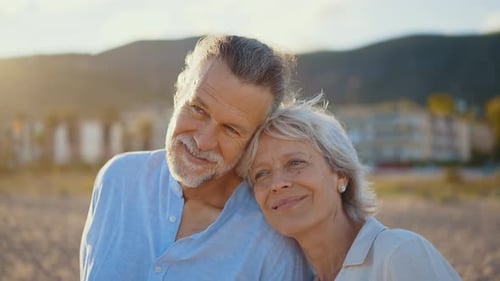 Mature married couple in love bonding outdoors at the beach