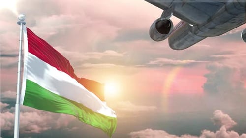 Waving National Flag and Airplane Flying at Sunset