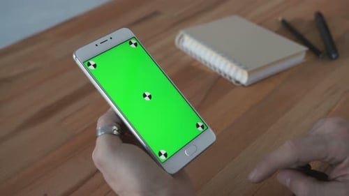 One Businessman Use the Handheld Cellphone with Greenscreen Touchpad and Gesturing Close