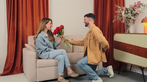 Man Proposes to Woman with Roses and Ring