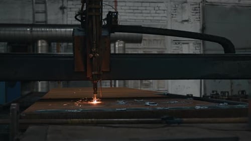 Industrial Welding Machine Operating on Steel Plates in Metalworking Shop