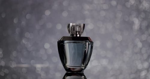 Perfume Bottle Close Up on Sparkling Background