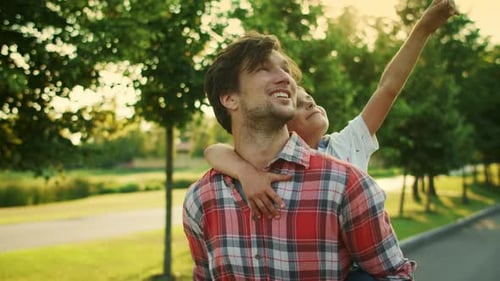 Closeup Happy Father and Son Walking on Street. Portrait of Smiling Man