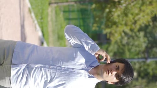 Young Adult Talking on Phone Outside