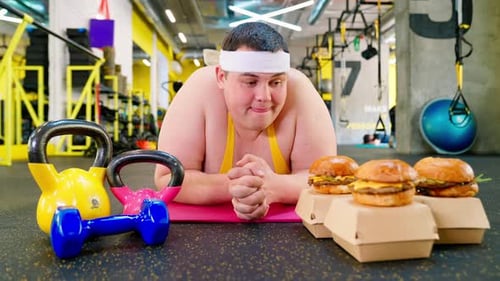 Man Longs for Burgers While Lying on Gym Mat