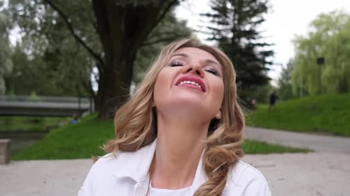 Blonde Woman Smiling in Park