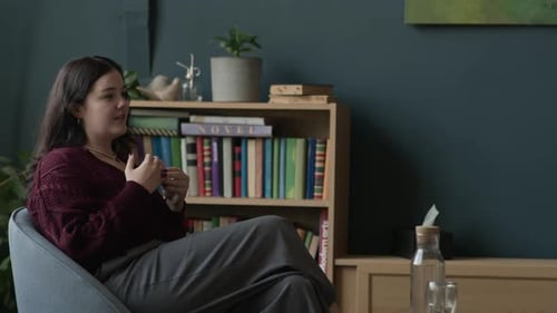 Female Psychologist Giving Advice to Young Woman during Counseling Session