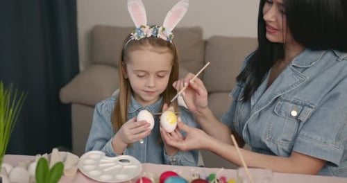 Mother with Daughter Painting Eggs for Easter