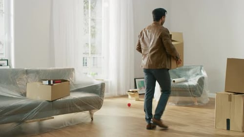 Man Carrying Boxes Into New Home