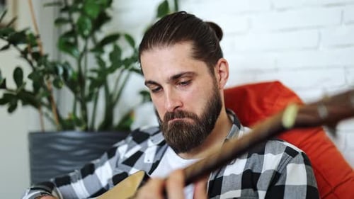 Man Plays Acoustic Guitar Indoors