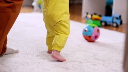 Infant Takes First Steps on Carpet at Home