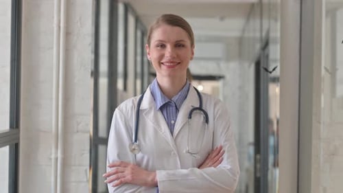 Portrait of Smiling Young Female Doctor Looking at Camera