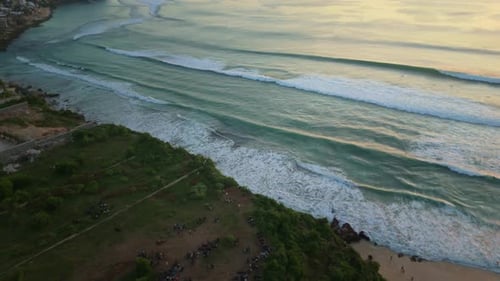 Drone flight over the ocean, watching the sunset and coastline. Dreamland Beach, Bali