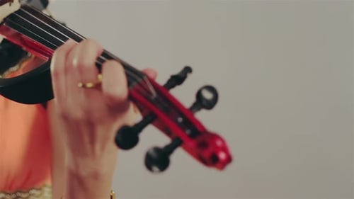 Woman Plays Electric Violin with Energetic Fervor