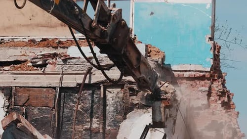 Excavator Hydraulic Hammer Breaking Concrete Structure During Demolition Work