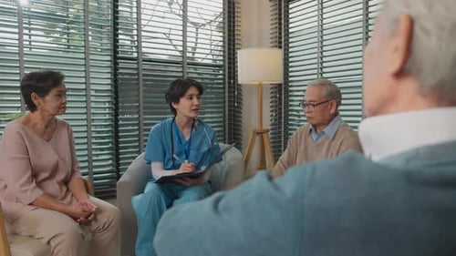 Medical Professional Visits Elderly Couple at Home