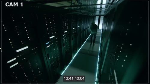 Security Camera N1 Footage of Hacker in a Hoodie Inflitrating Data Center, With His Laptop He Conne