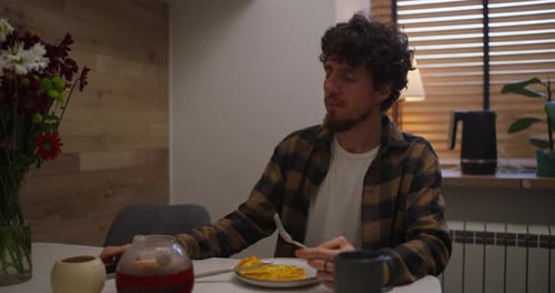 Young Adult Male Eating Breakfast