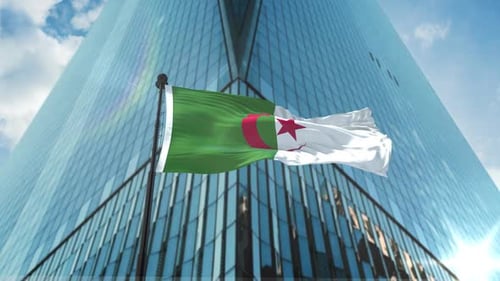 Algeria Flag Waving in Wind with Modern Skyscraper Background