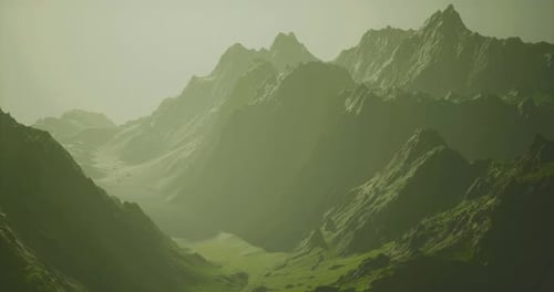 Majestic Mountain Landscape with Mist and Lush Green Slopes at Dawn