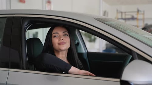 Young Woman Holding Car Keys in New Car