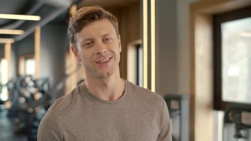 Portrait Of Confident Bodybuilder Smiling At Gym. Closeup Handsome Sportsman Looking At Camera In...