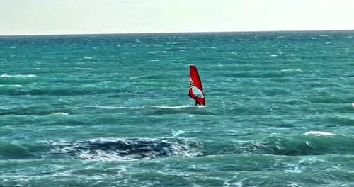 Drone Footage of Windsurfing in the Sea Board with Sail Gliding Over Ocean Waves