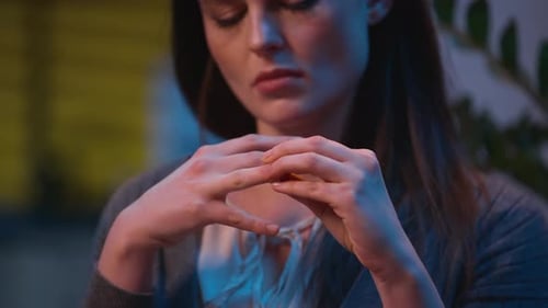 Distressed Woman Removing Ring in Home Interior