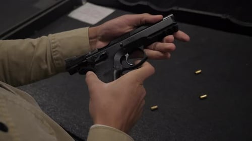 Guy Inspecting a 9mm Pistol