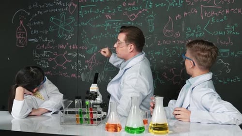 Science Teacher Explains Chemistry to Students in Classroom