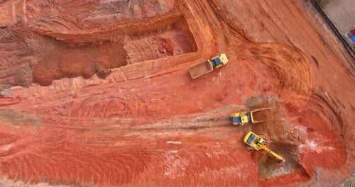 Construction Site Aerial with Trucks and Bulldozer
