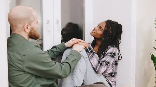 Loving Couple Talking and Holding Hands Indoors