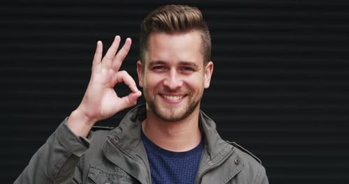 Young Adult Man Gives OK Hand Sign