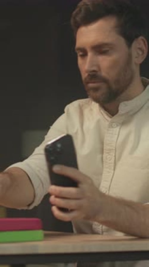 Man At Desk Using Cell Phone Device Indoors