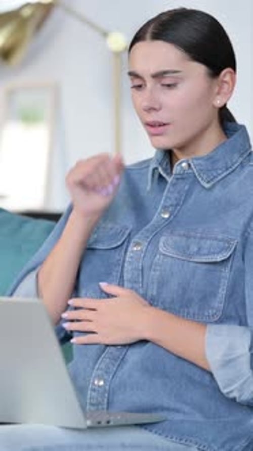 Sick Woman Coughing While Working on Laptop