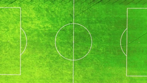 Empty soccer field. Green field of a new football stadium. Camera rising up.