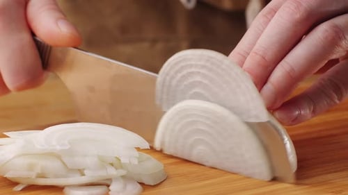 Chef Chopping a Red Onion with a Knife on the Cutting Board Macro Close Up of Cutting Red Onion on