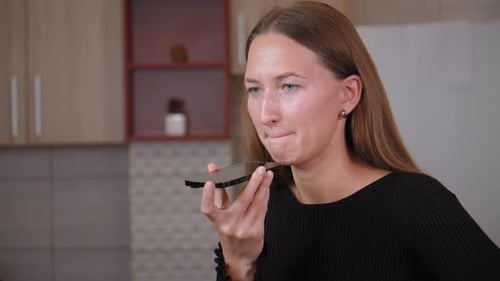 Woman Using Voice Memo on Mobile Phone Indoors