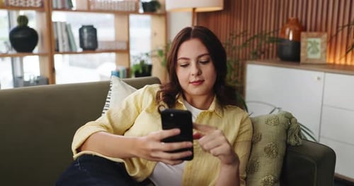 Phone, scroll and social media with woman on sofa in living room of home for post or update