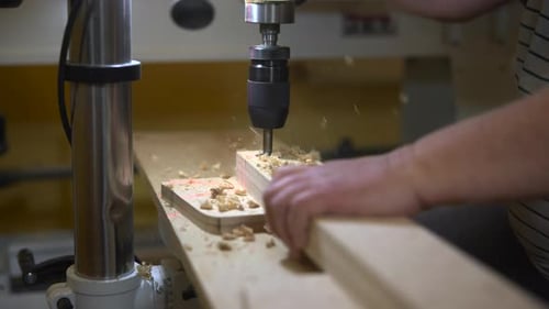 Joiner Operating Drill Press Skillfully Woodworker Carefully Drilling Panels In Wellequipped Shop