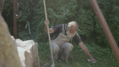Male Sculptor Cleaning Workplace